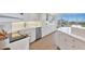 Bright white kitchen with stainless steel appliances and wood floors at 5300 Ocean Blvd # 202, Sarasota, FL 34242