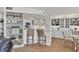Open concept kitchen with white cabinets, bar seating, and stylish display shelving at 5300 Ocean Blvd # 202, Sarasota, FL 34242