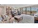 Cozy living room with comfortable seating, built-in shelving, and a view of the beach at 5300 Ocean Blvd # 202, Sarasota, FL 34242