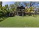 Unique backyard structure featuring rustic wood and screened porch, surrounded by lush greenery at 5307 22Nd W Ave, Bradenton, FL 34209