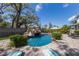 Resort-style pool with a rock waterfall feature, surrounded by lush landscaping and seating areas at 5307 22Nd W Ave, Bradenton, FL 34209