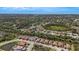 Aerial view of community showcasing the home's location among lush greenery, pristine landscaping, and the neighborhood layout at 5329 Trails Bend Ct, Sarasota, FL 34238