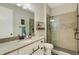 Well lit bathroom featuring single vanity and glass walk-in shower with tiled accents at 5329 Trails Bend Ct, Sarasota, FL 34238