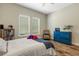 Comfortable bedroom featuring light walls, hardwood floors, and a large window for plenty of natural light at 5329 Trails Bend Ct, Sarasota, FL 34238