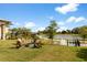 Common area with a fire pit, lake views, and an outdoor chess set for relaxation and recreation at 5329 Trails Bend Ct, Sarasota, FL 34238