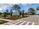 Welcome to Legacy Estates entrance sign featuring lush landscaping, flowers, and mature trees at 5329 Trails Bend Ct, Sarasota, FL 34238