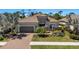 Charming single-story home with a brick driveway, neutral colors, stone accents, and manicured landscaping at 5329 Trails Bend Ct, Sarasota, FL 34238