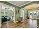 Spacious foyer showcases hardwood floors, a decorative chandelier, and inviting green-painted walls and trim at 5329 Trails Bend Ct, Sarasota, FL 34238