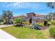 Charming single-story home features a tile roof, manicured lawn, stone accents, and a gated front entry for added privacy at 5329 Trails Bend Ct, Sarasota, FL 34238