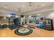 Bright fitness center with modern equipment, weights, and large windows overlooking the manicured landscaping at 5329 Trails Bend Ct, Sarasota, FL 34238