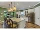 Open kitchen with a large island, granite countertops, stainless steel appliances, and hardwood floors at 5329 Trails Bend Ct, Sarasota, FL 34238