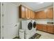 Well-organized laundry room with ample cabinet space, modern washer and dryer, and convenient layout at 5329 Trails Bend Ct, Sarasota, FL 34238