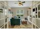 Cozy living room features a comfortable couch, and lots of storage, framed by elegant French doors at 5329 Trails Bend Ct, Sarasota, FL 34238