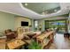 Cozy living room features hardwood floors, ceiling fan and a seamless flow to the outdoor living area at 5329 Trails Bend Ct, Sarasota, FL 34238