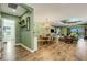 Open living and dining area with hardwood floors and views of outdoor living space with retractable sliding glass doors at 5329 Trails Bend Ct, Sarasota, FL 34238