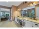 Dual sink vanity with granite counters leading to a spacious bathroom with glass shower and separate soaking tub at 5329 Trails Bend Ct, Sarasota, FL 34238