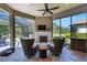 Relaxing outdoor seating area with fireplace, wicker chairs, and screened in lanai at 5329 Trails Bend Ct, Sarasota, FL 34238
