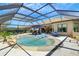 Enjoy the screened in private pool with waterfall feature, sun loungers, and tranquil views for ultimate relaxation and entertainment at 5329 Trails Bend Ct, Sarasota, FL 34238