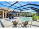 Relaxing screened pool area with outdoor seating, umbrella, and lounge chairs that offer an exceptional outdoor experience at 5329 Trails Bend Ct, Sarasota, FL 34238