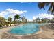 Large community pool offers plenty of space to relax with lounge chairs, lush landscaping, and a serene atmosphere at 5329 Trails Bend Ct, Sarasota, FL 34238
