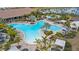 Aerial view of beautiful community pool featuring lounge chairs and tropical landscaping at 5329 Trails Bend Ct, Sarasota, FL 34238