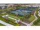 Aerial view of well-maintained tennis courts and beautiful landscaping at 5329 Trails Bend Ct, Sarasota, FL 34238
