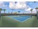 Community tennis courts for residents to enjoy with vibrant blue and green colors under a bright blue sky at 5329 Trails Bend Ct, Sarasota, FL 34238