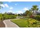 Picturesque community walking path with mature landscaping and a serene lake view for residents to enjoy at 5329 Trails Bend Ct, Sarasota, FL 34238