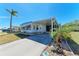 Well-maintained single-story home with a spacious carport and tropical landscaping at 5619 Bayshore Rd # 423, Palmetto, FL 34221