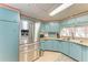The kitchen boasts stainless steel appliances, ample counter space, and blue cabinets at 5619 Bayshore Rd # 423, Palmetto, FL 34221