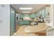Bright kitchen features stainless steel appliances, blue cabinetry, and an adjacent dining area at 5619 Bayshore Rd # 423, Palmetto, FL 34221