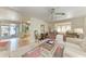 Bright living room features a ceiling fan and an open floor plan leading to a dining area and a bonus sitting room at 5619 Bayshore Rd # 423, Palmetto, FL 34221