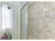 Shower stall features a stylish design and frosted glass doors and light coming through the window at 5619 Bayshore Rd # 423, Palmetto, FL 34221