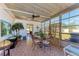 Bright sunroom featuring a glass table, floral chairs, and many windows at 5619 Bayshore Rd # 423, Palmetto, FL 34221