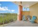 Inviting balcony with seating, offering a serene view of surrounding greenery and water at 611 Riviera Dunes Way # 107, Palmetto, FL 34221