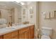 Well-lit bathroom with a large mirror, modern fixtures, and tiled shower at 611 Riviera Dunes Way # 107, Palmetto, FL 34221