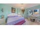 Charming bedroom with a lilac theme, featuring a view of the water, a desk, and a chandelier at 611 Riviera Dunes Way # 107, Palmetto, FL 34221
