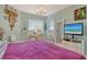 Serene bedroom showcasing beach view on television, complemented by pastel decor and a comfortable bed at 611 Riviera Dunes Way # 107, Palmetto, FL 34221