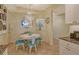 Dining room with a chandelier, a round mirror, and blue chairs around a table at 611 Riviera Dunes Way # 107, Palmetto, FL 34221