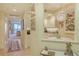 Hallway view of dining room and kitchen with charming decor and water view beyond at 611 Riviera Dunes Way # 107, Palmetto, FL 34221