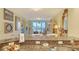 Kitchen featuring granite countertops, a stainless steel sink, and a living room view at 611 Riviera Dunes Way # 107, Palmetto, FL 34221