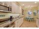 Bright kitchen featuring granite countertops, stainless steel appliances, and a cozy breakfast nook at 611 Riviera Dunes Way # 107, Palmetto, FL 34221