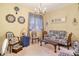 Stylish sitting room featuring patterned fabrics, a chandelier, and ornate decorations with light yellow walls at 611 Riviera Dunes Way # 107, Palmetto, FL 34221