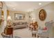 Cozy living room with classic decor, featuring plush seating, lamps, and ornate wall decorations at 611 Riviera Dunes Way # 107, Palmetto, FL 34221