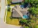Aerial view of a single-Gathering home showcasing its backyard pool, mature trees, and well-maintained landscaping at 6602 Peach Tree Creek Rd, Bradenton, FL 34203