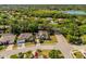 Beautiful aerial view of neighborhood with manicured lawns, mature trees, and lake views at 6602 Peach Tree Creek Rd, Bradenton, FL 34203