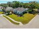 Aerial view of home showcasing lush landscaping, manicured lawn, and a serene view of the surrounding neighborhood at 6602 Peach Tree Creek Rd, Bradenton, FL 34203