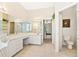 Primary bathroom featuring dual sinks, a bathtub, and vanity area with drawers at 6602 Peach Tree Creek Rd, Bradenton, FL 34203