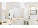 Well-lit bathroom with a large mirror, patterned wallpaper, and ample counter space at 6602 Peach Tree Creek Rd, Bradenton, FL 34203