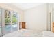 Bright bedroom featuring sliding glass doors to the pool area and a traditional dresser at 6602 Peach Tree Creek Rd, Bradenton, FL 34203